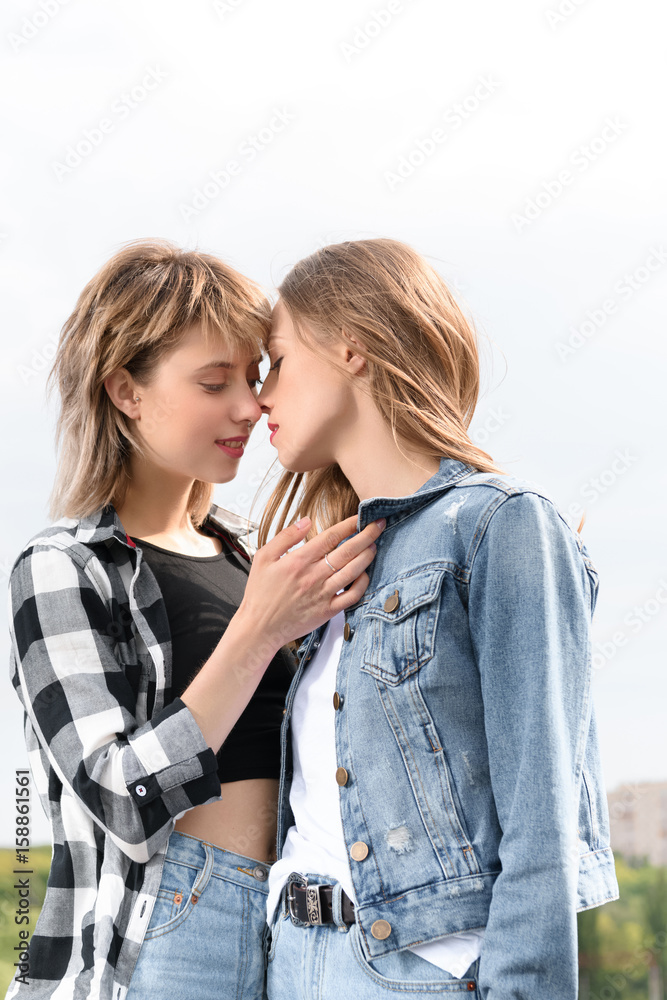 Old and young lesbian kissing